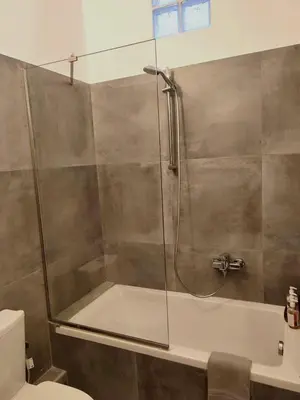 a shower with a glass door in a bathroom at Ulysses Apartments Acropolis in Athens