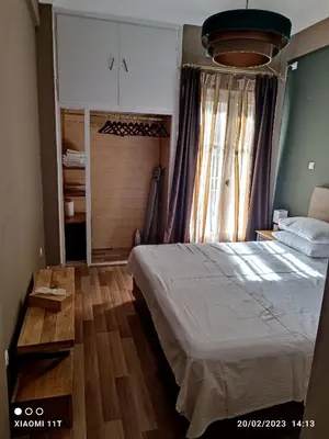 a bedroom with a bed and a large window at Ulysses Apartments Acropolis in Athens