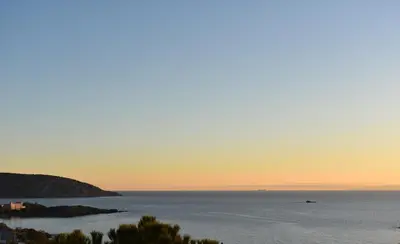 a view of the ocean at sunset at El Mar Seaview Penthouse 2 BDR, 7 min from beach in Lagonissi