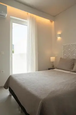 a bedroom with a large bed and a window at El Mar Seaview Penthouse 2 BDR, 7 min from beach in Lagonissi