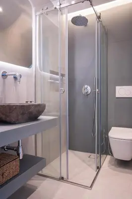 a bathroom with a glass shower with a sink and a toilet at El Mar Seaview Penthouse 2 BDR, 7 min from beach in Lagonissi