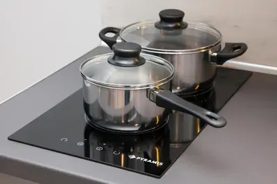 a pair of pots sitting on top of a stove at Walk to Markets from a Cozy Studio by Cielo Homes in Athens