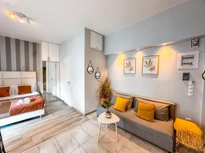 a living room with a couch and a bed at Walk to Markets from a Cozy Studio by Cielo Homes in Athens