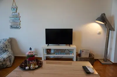 a living room with a flat screen tv on a wall at Seaview apartment in Piraeus