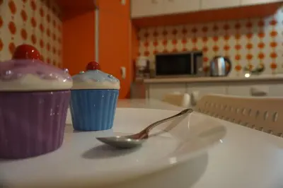 two cups sitting on a table with a spoon at Seaview apartment in Piraeus