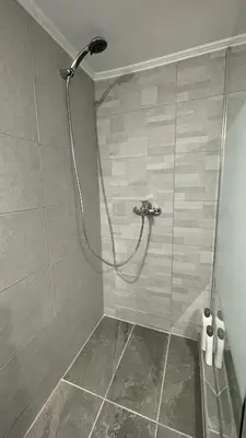 a shower with a shower head in a bathroom at Seaview apartment in Piraeus