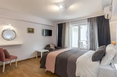 a hotel room with a bed and a window at UrbanStay in Athens