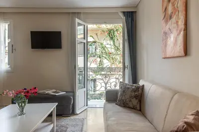 a living room with a couch and a table at UrbanStay in Athens