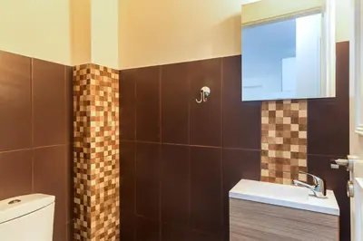 a bathroom with a sink and a toilet at UrbanStay in Athens