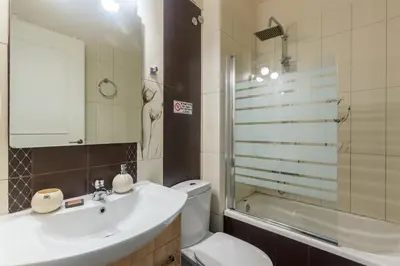 a bathroom with a sink and a toilet and a shower at UrbanStay in Athens