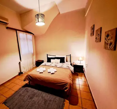 a bedroom with a bed with two towels on it at House with yard Subway 5min walk in Athens