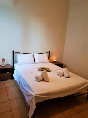 a bedroom with a bed with two pillows on it at House with yard Subway 5min walk in Athens