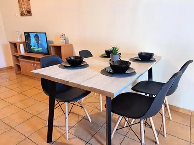 a wooden table with four black bowls on it at House with yard Subway 5min walk in Athens