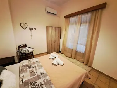 a bedroom with a bed with towels on it at House with yard Subway 5min walk in Athens