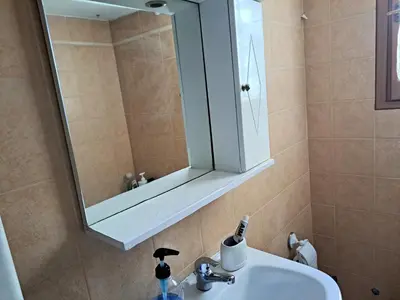 a bathroom with a sink and a mirror at House with yard Subway 5min walk in Athens