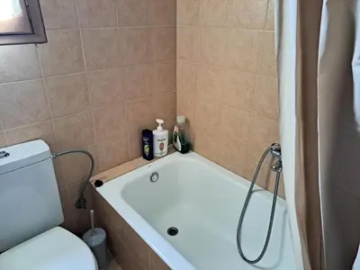 a bathroom with a bath tub and a toilet at House with yard Subway 5min walk in Athens