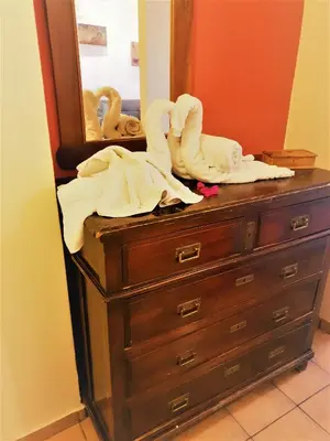 a dresser with towels sitting on it in front of a mirror at House with yard Subway 5min walk in Athens