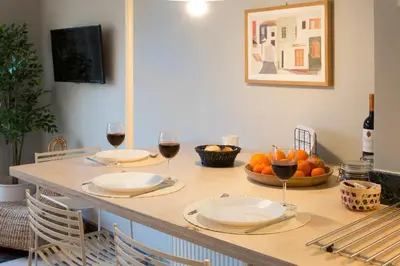 a table with two glasses of wine and fruit on it at Auntie’s Home in Athens