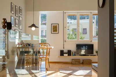 a living room with a glass table and a television at Auntie’s Home in Athens