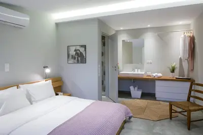 a bedroom with a bed and a bathroom with a sink at Auntie’s Home in Athens