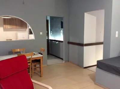a kitchen and dining room with a table and a refrigerator at Renovated apartment in Athens