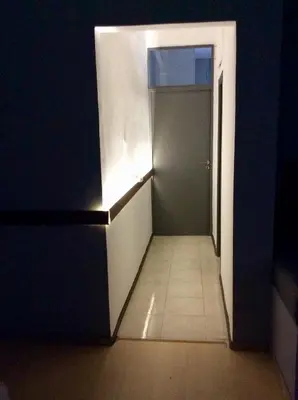 a hallway with a door and a tile floor at Renovated apartment in Athens