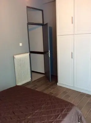 a bedroom with a door leading to a closet at Renovated apartment in Athens