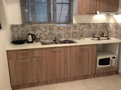 a kitchen with a sink and a microwave at Renovated apartment in Athens