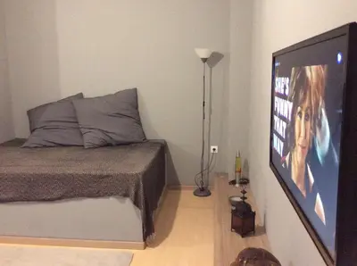 a bedroom with a bed and a flat screen tv at Renovated apartment in Athens