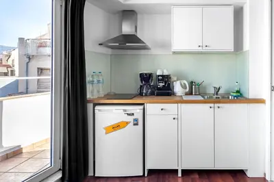a kitchen with a white refrigerator and a sink at Loft in Athens