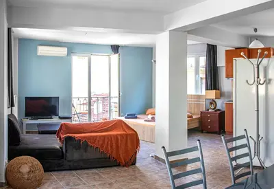 a living room with a couch and a room with a bed at Loft in Athens