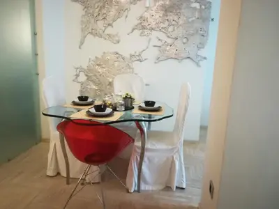 a table and chairs in a room with a wall at The Best Spot in The Center in Athens