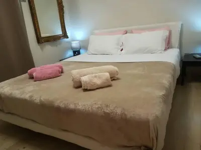 a bedroom with a bed with two towels on it at The Best Spot in The Center in Athens
