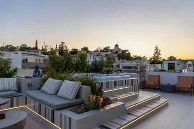 a rooftop patio with furniture and a view of the city at Meros - Athenian Residencies in Athens