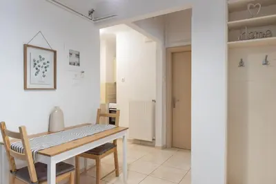 a dining room with a table and chairs at Meros - Athenian Residencies in Athens
