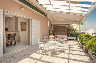 a patio with a table and chairs on a balcony at Athens View in Athens