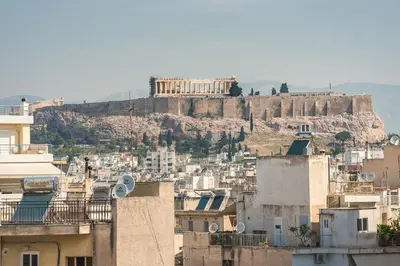 a view of the acropolis from a city with buildings at Athens View in Athens