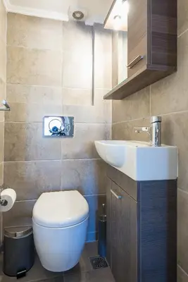a bathroom with a white toilet and a sink at Athens View in Athens