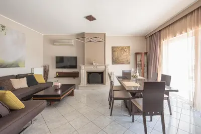 a living room with a couch and a table at Athens View in Athens