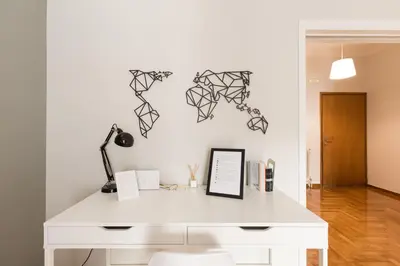 a white desk with a lamp on a white wall at Sleek Flat in Central Syntagma by UPSTREET in Athens