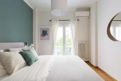 a bedroom with a white bed and a window at Sleek Flat in Central Syntagma by UPSTREET in Athens