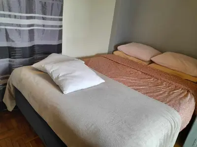 two beds in a room with two pillows on them at For Harbor Travelers in Piraeus