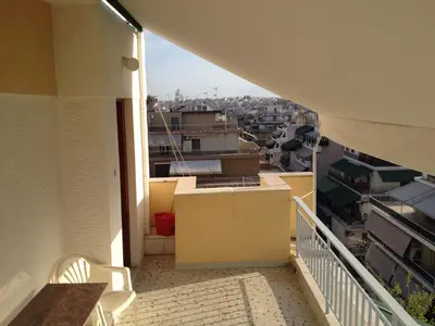 a balcony with a view of a city at For Harbor Travelers in Piraeus