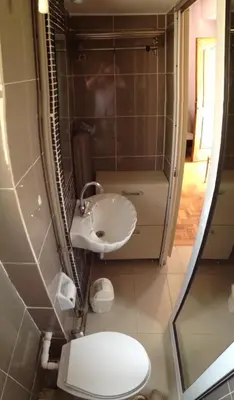 a small bathroom with a toilet and a sink at For Harbor Travelers in Piraeus