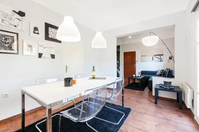 a kitchen and living room with a table and chairs at Trendy Minimal Flat in posh Athens in Athens
