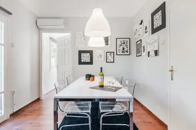 a dining room with a white table and chairs at Trendy Minimal Flat in posh Athens in Athens