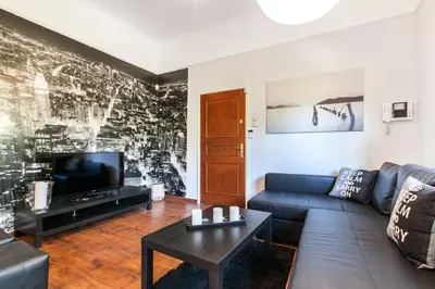 a living room with a couch and a tv at Trendy Minimal Flat in posh Athens in Athens