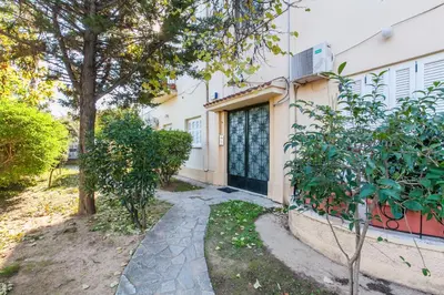 a house with a door and trees in front of it at Trendy Minimal Flat in posh Athens in Athens