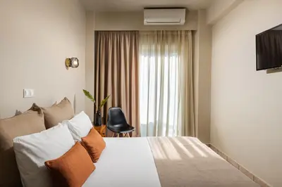 a hotel room with a bed and a window at Hotel Delfini in Piraeus