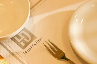 a plate and a fork on a table at Hotel Delfini in Piraeus